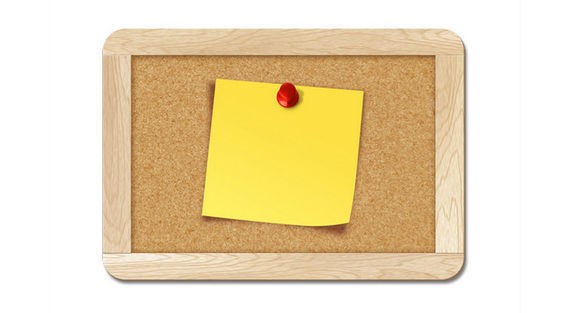 Blank note pinned to corkboard